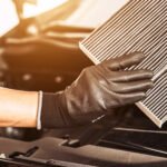 Dirty car air filter showing dust buildup affecting engine performance.